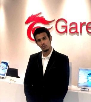 Me as Remixer, my casting name, at a Garena logo wall in 2022